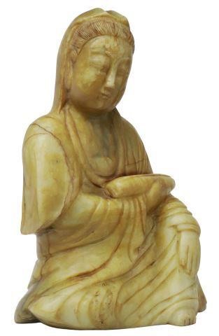 Appraisal: Chinese carved stone seated Guanyin with draped robes holding a