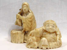 Appraisal: An ivory netsuke in the form of a man and