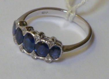 Appraisal: A SAPPHIRE AND DIAMOND RING having five oval cut graduated