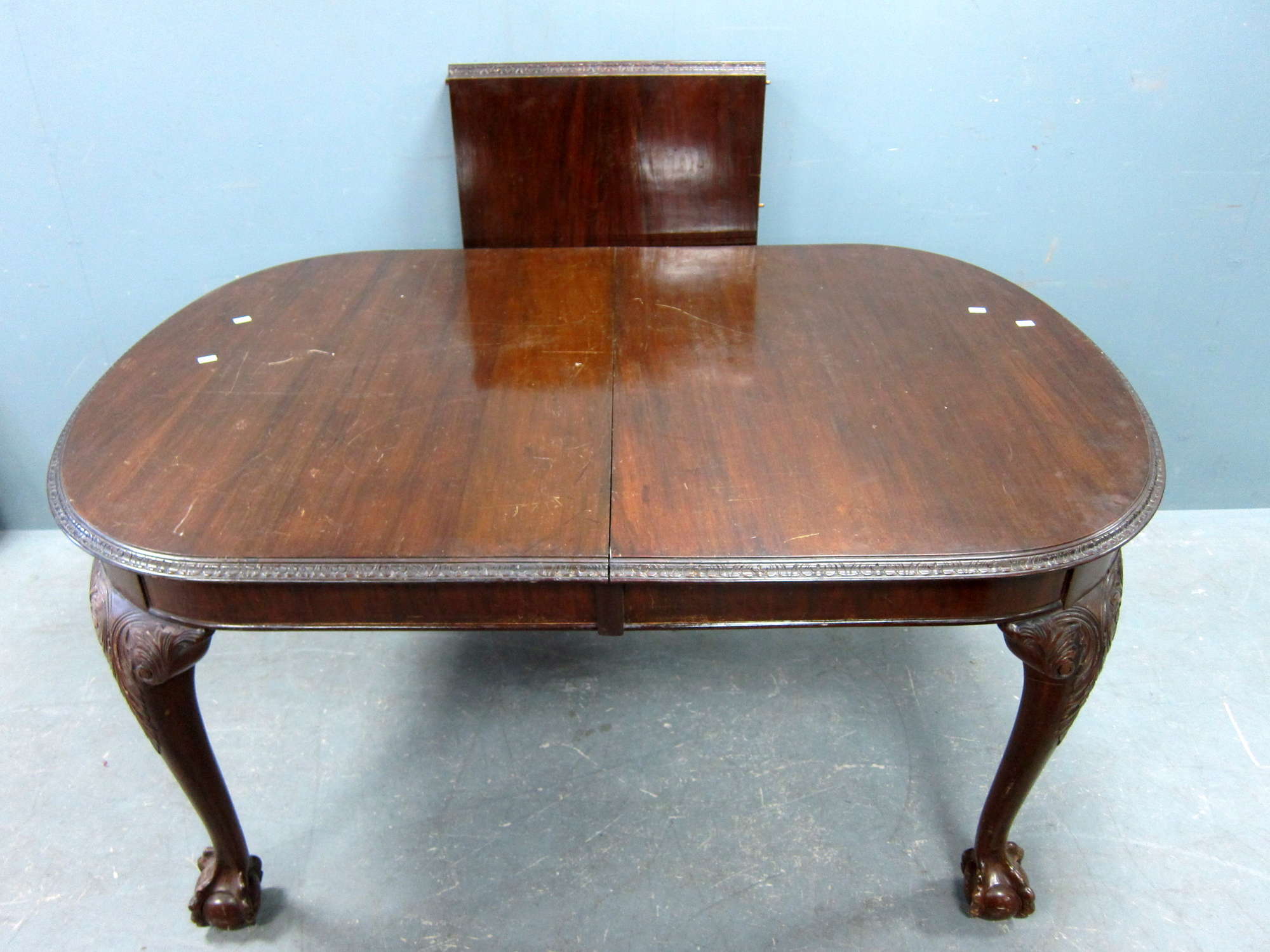 Appraisal: Mahogany extending dining table on carved legs to ball and