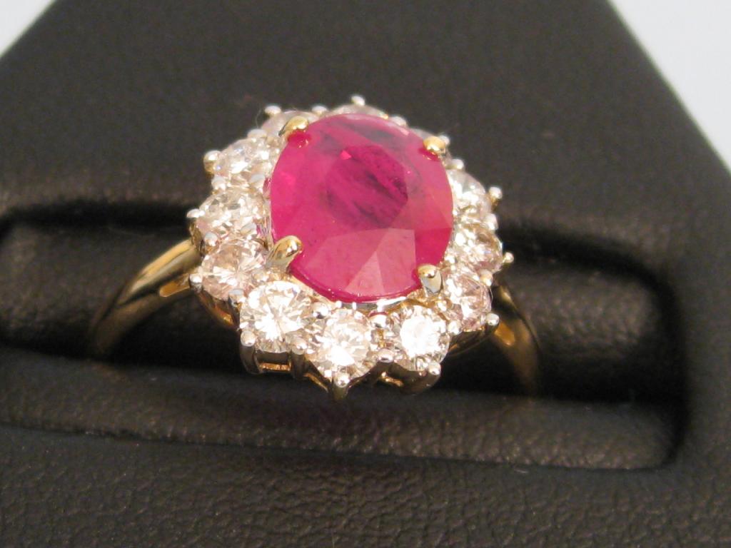 Appraisal: A Ruby and Diamond Cluster Ring claw-set with oval shaped