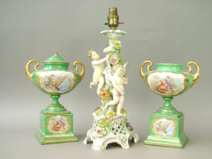 Appraisal: A continental porcelain floral and putto mounted candlestick converted to