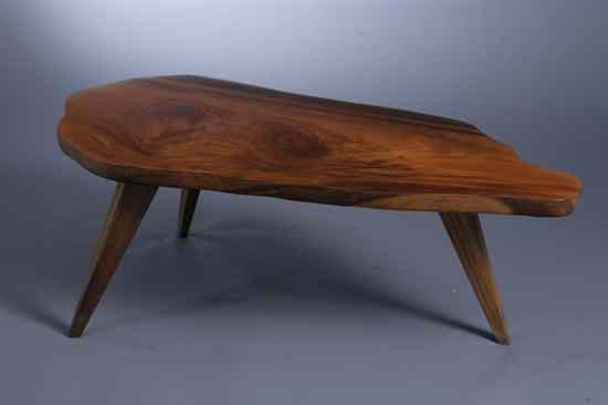 Appraisal: MID-CENTURY MODERN WOOD LOW TABLE Asymetrical oblong top rests on