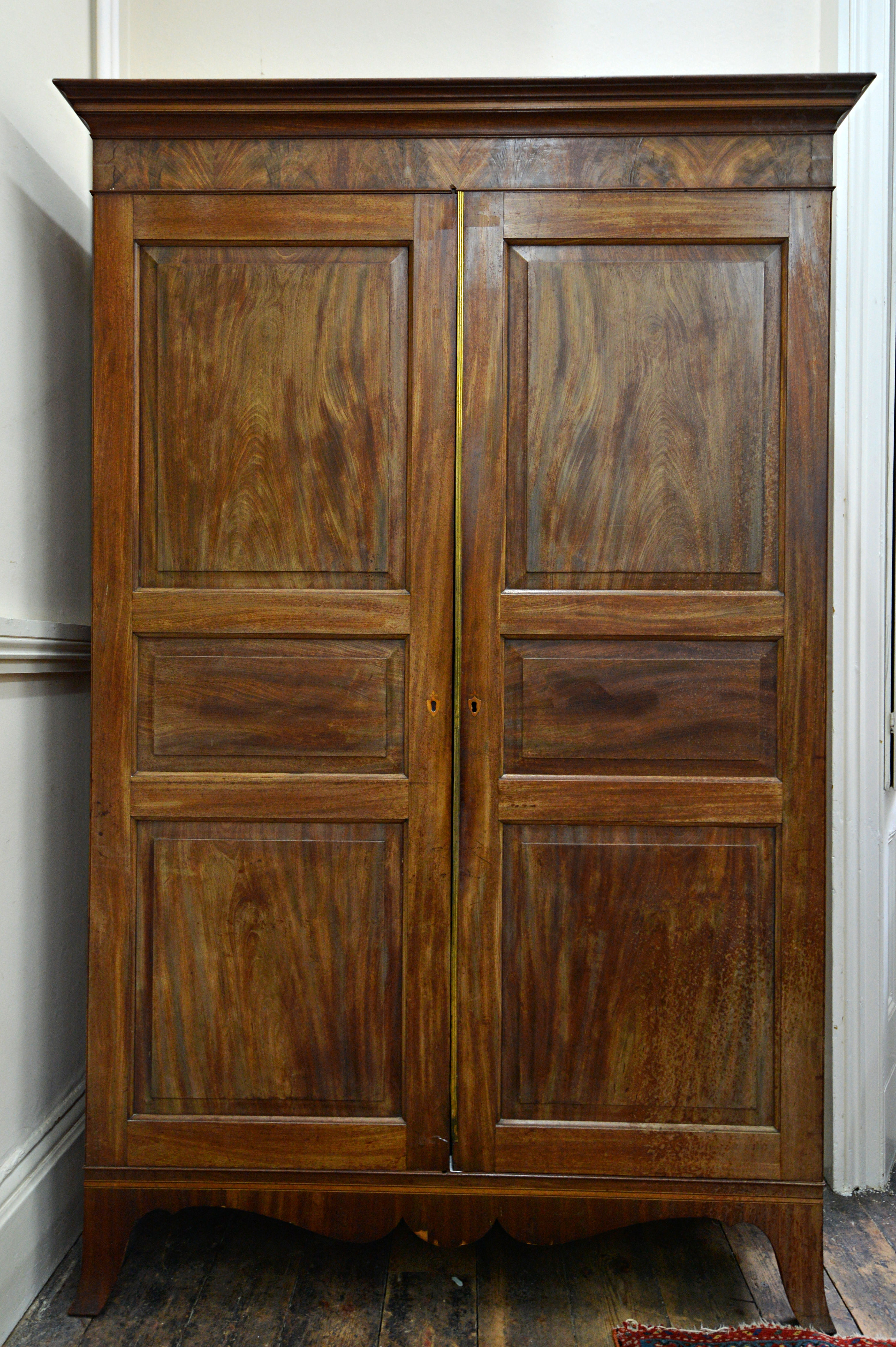 Appraisal: A George III mahogany Channel Islands wardrobe of panelled construction