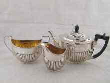 Appraisal: A three piece matched tea set of half fluted design