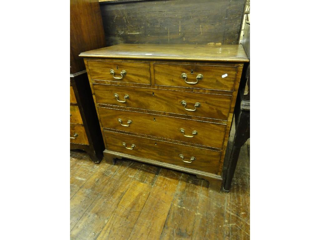 Appraisal: A small Georgian mahogany chest fitted with three long and