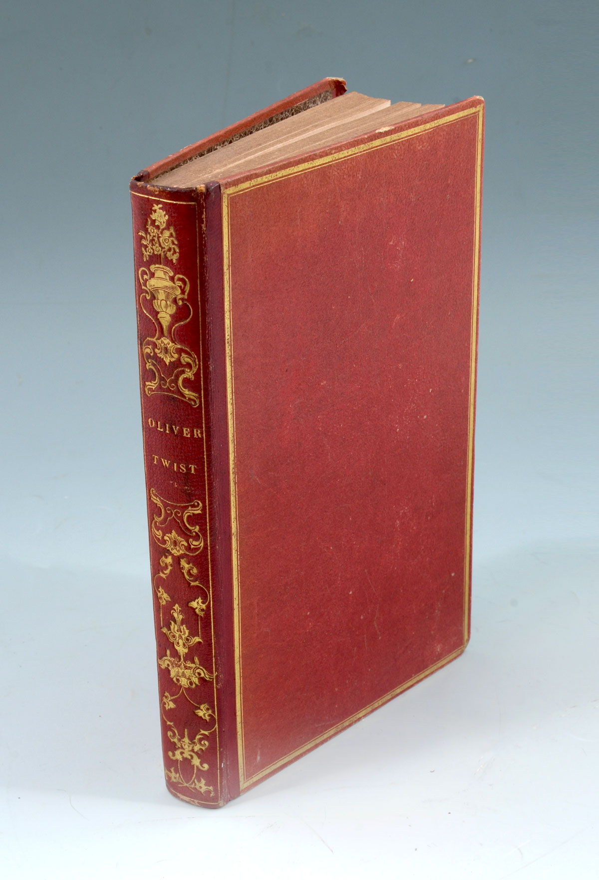 Appraisal: OLIVER TWIST BOOK Parisian red leather bound Charles Dickens ''Oliver