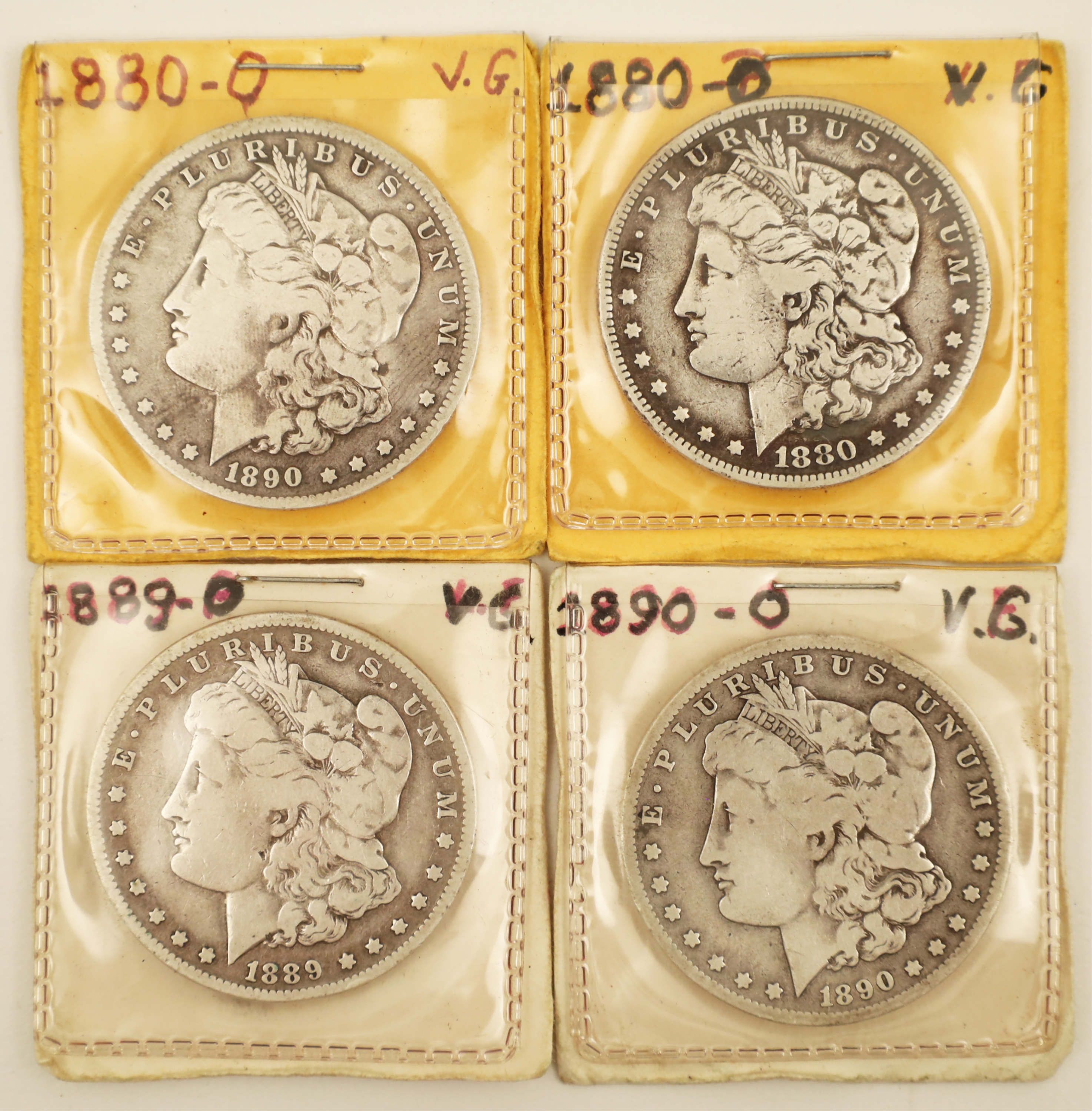 Appraisal: FOUR EARLY AMERICAN MORGAN SILVER DOLLARS Four early American Morgan