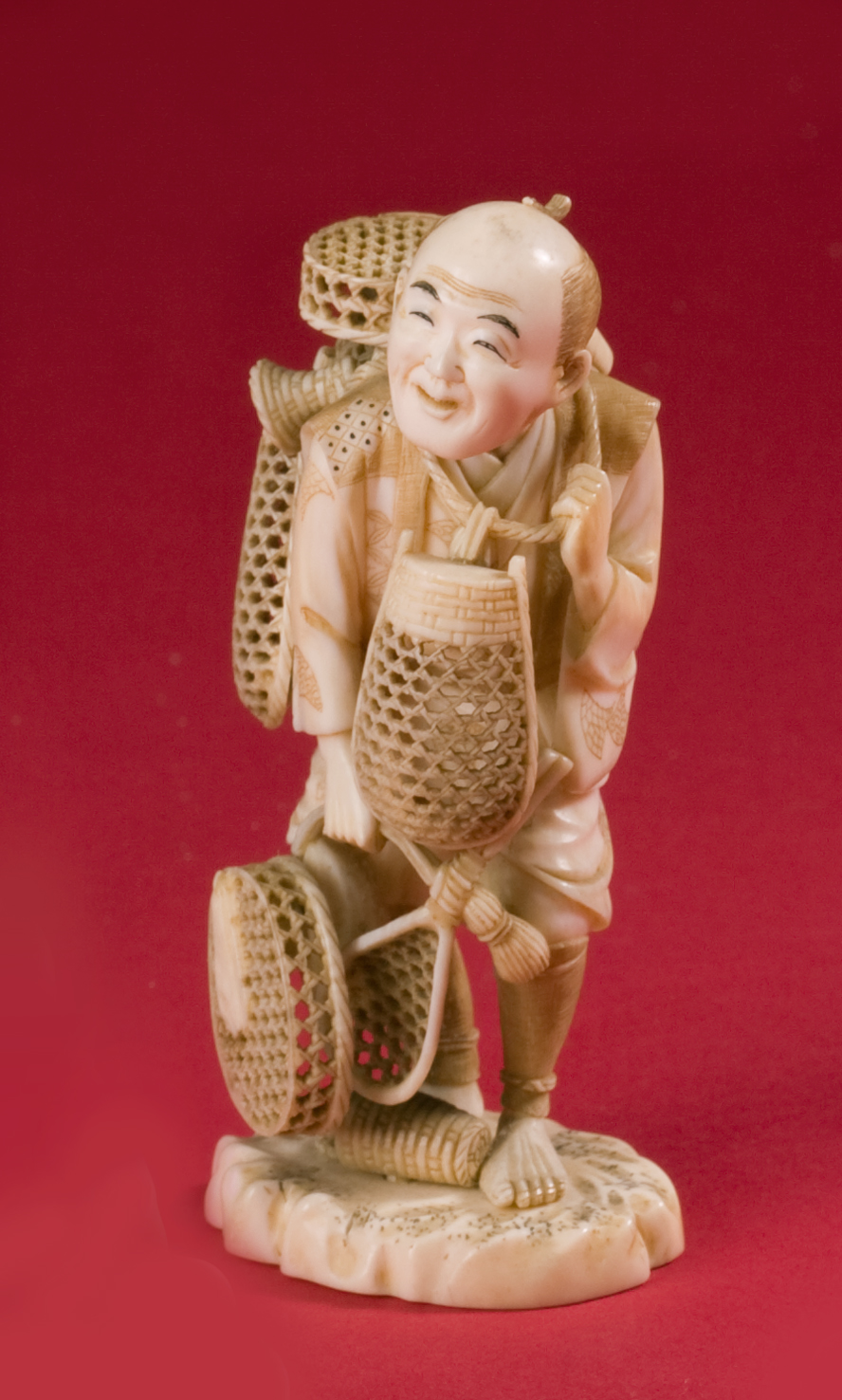 Appraisal: JAPANESE CARVED AND PIERCED FIGURE OF A STANDING MAN Holding