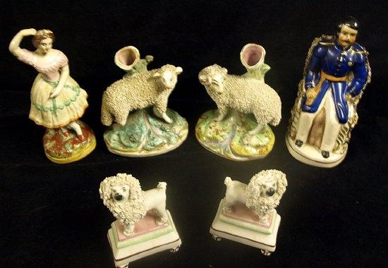 Appraisal: A pair of pottery spill vases modelled as sheep on