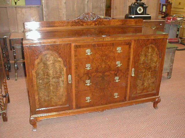 Appraisal: A walnut quarter veneered sideboard with brass handles Dimensions ins