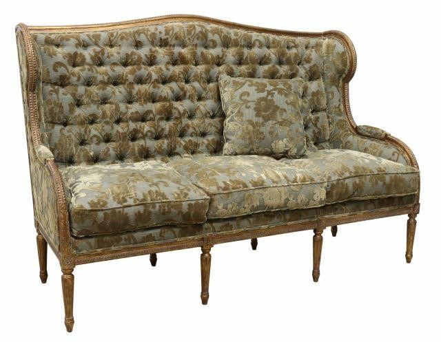 Appraisal: Louis XVI style wingback sofa th c giltwood frame with