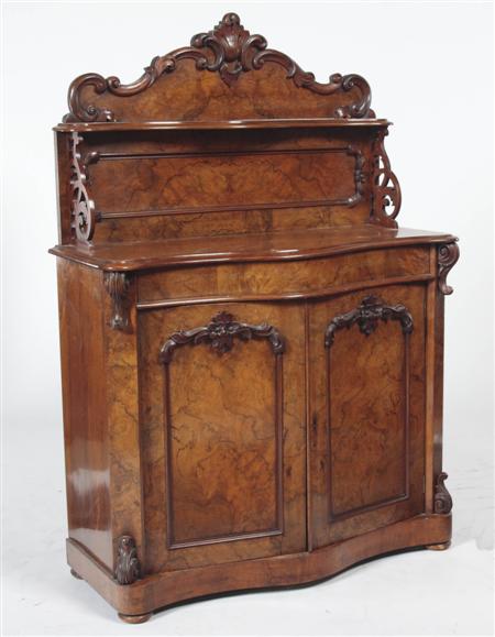 Appraisal: A Victorian walnut chiffonier the foliate carved arched backboard with