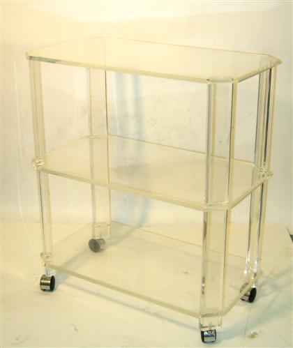 Appraisal: A lucite tea trolley With rectangular notched beveled edge shelves