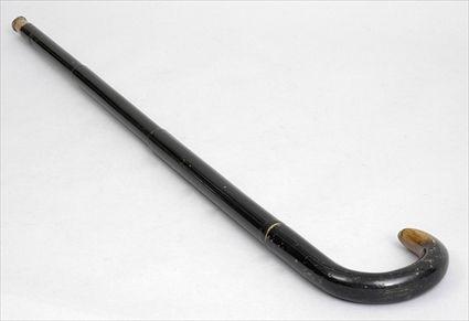 Appraisal: HORN-HANDLED BLACK LACQUER CANE ENCLOSING AN UMBRELLA The -part collapsible