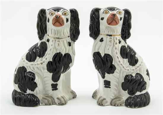 Appraisal: A Pair of Staffordshire Spaniels in a seated pose Height