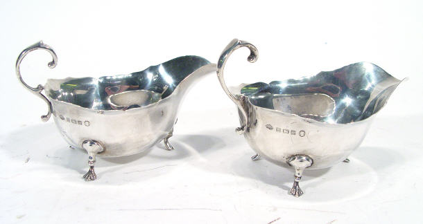 Appraisal: Pair of three footed silver sauce boats Birmingham each cm