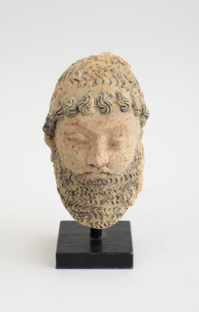 Appraisal: GANDHARAN CLAY HEAD OF A SATRAP The bearded face with