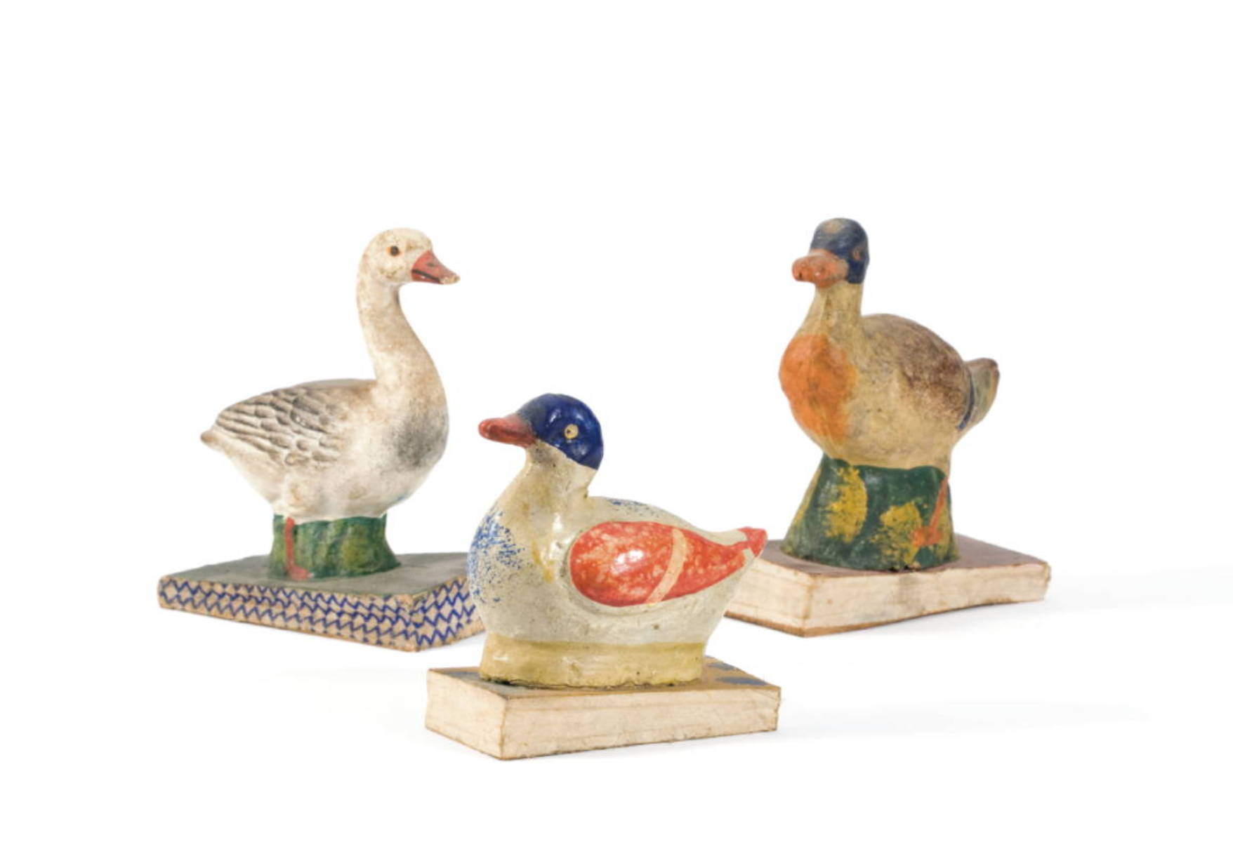 Appraisal: THREE PAINTED PAPIER MACHE WOOD AND CLOTH BIRD SQUEAK TOYS