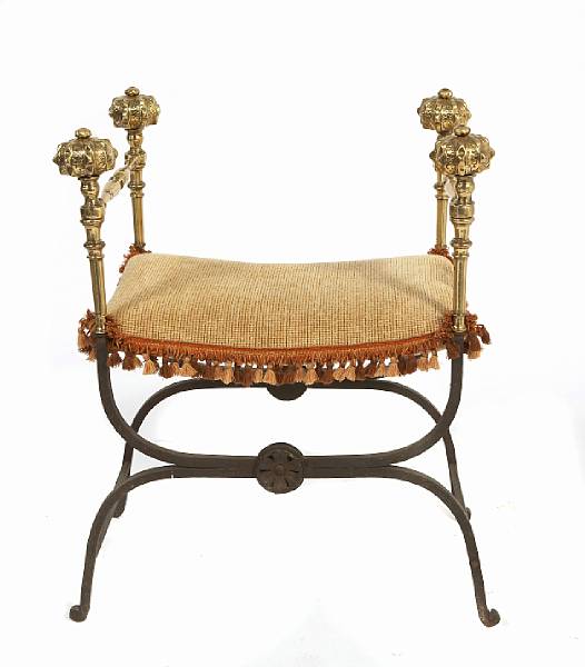 Appraisal: A brass and wrought iron curule chair height in width