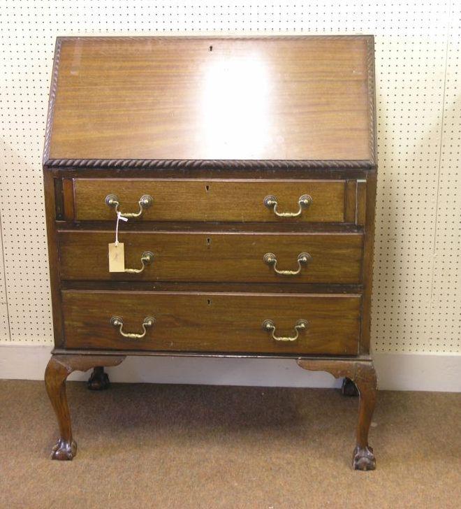 Appraisal: A George V mahogany bureau fall-front with carved gadrooned rim