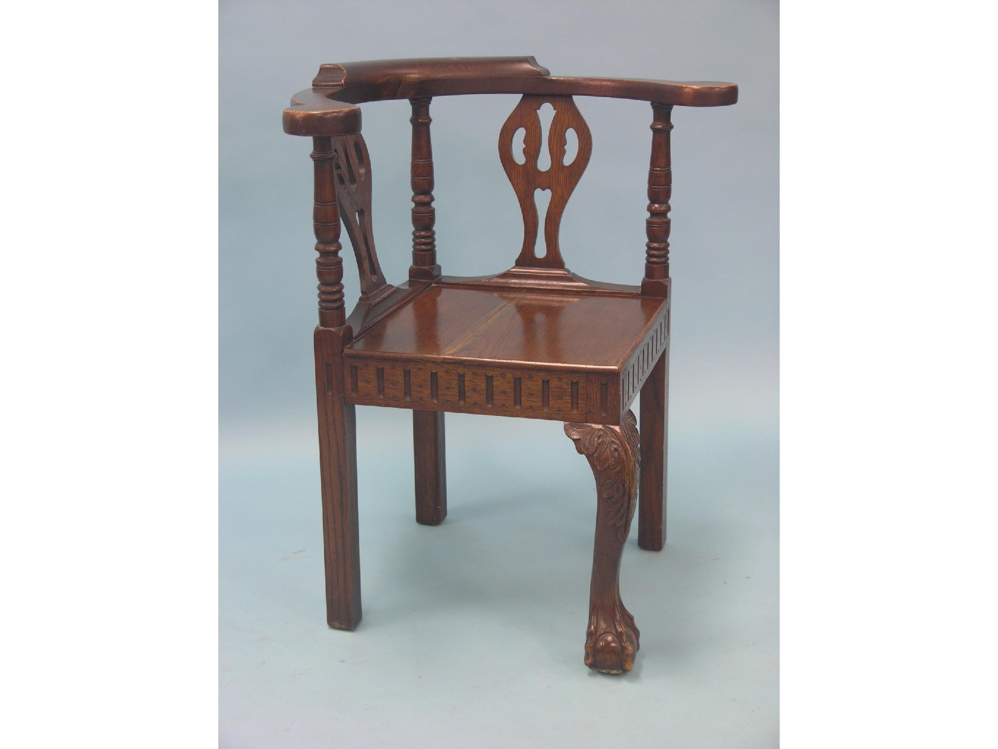 Appraisal: A Chippendale-style oak corner-fitting elbow chair with pierced splats front