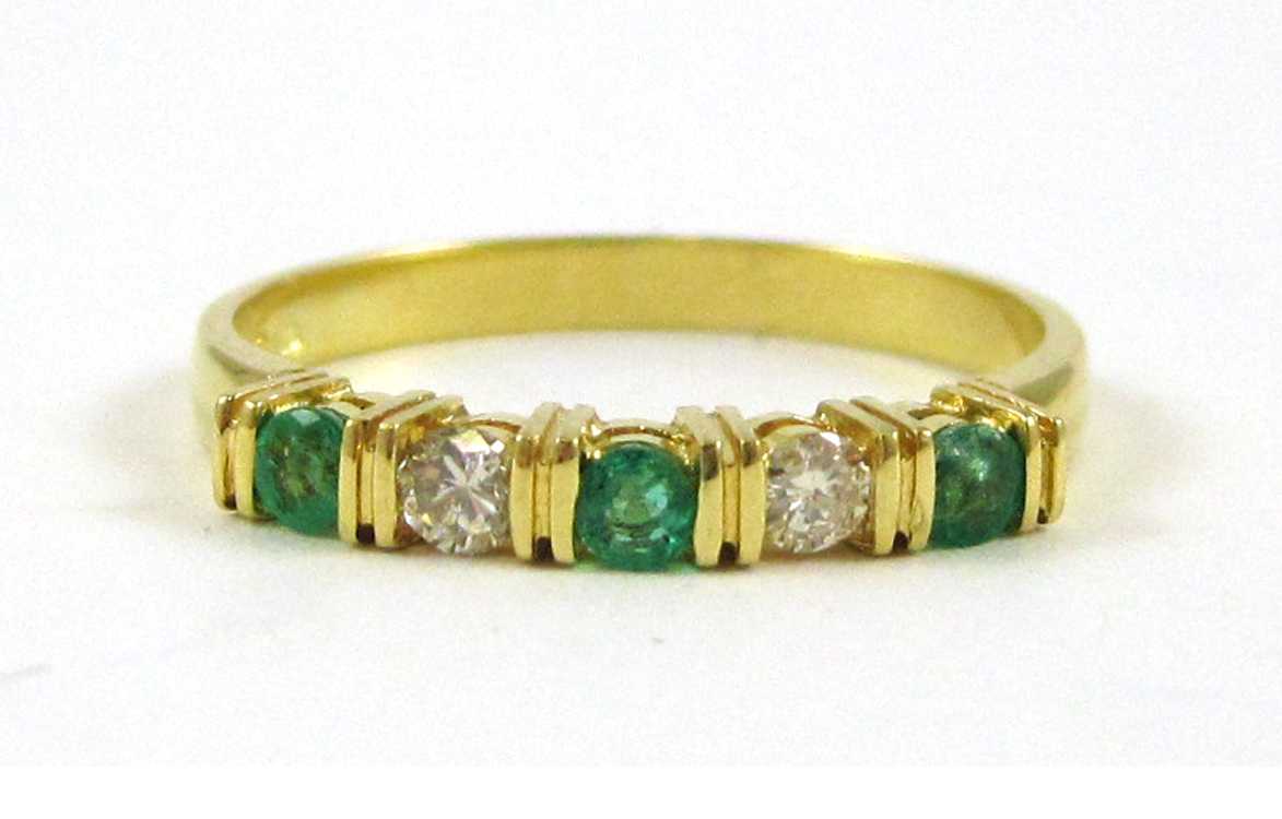 Appraisal: EMERALD DIAMOND AND EIGHTEEN KARAT GOLD RING set with three