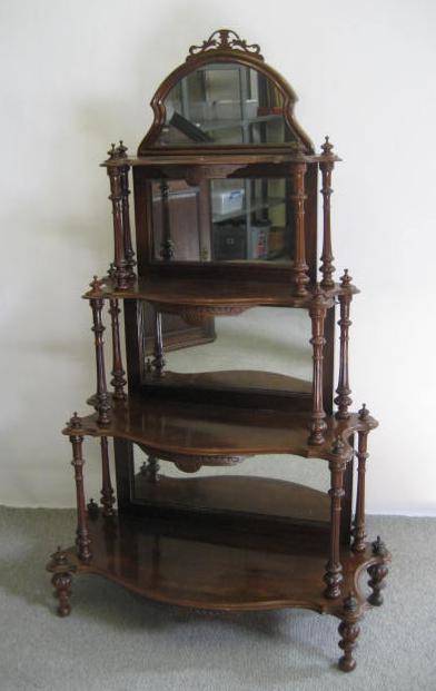 Appraisal: A VICTORIAN WALNUT WHATNOT comprising four shaped oblong graduated mirror