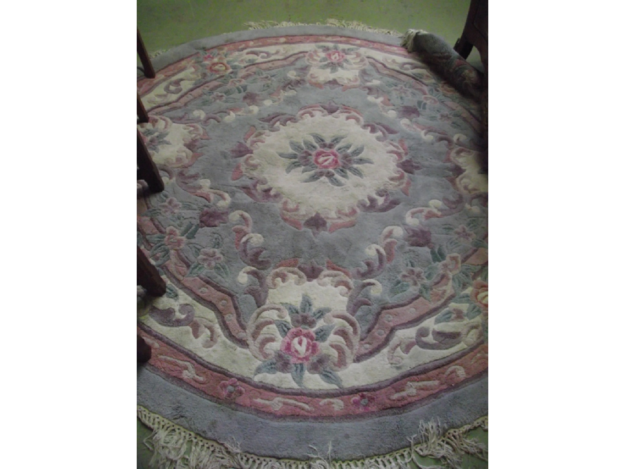 Appraisal: A Chinese woolwork rug of circular form pale pastel shades