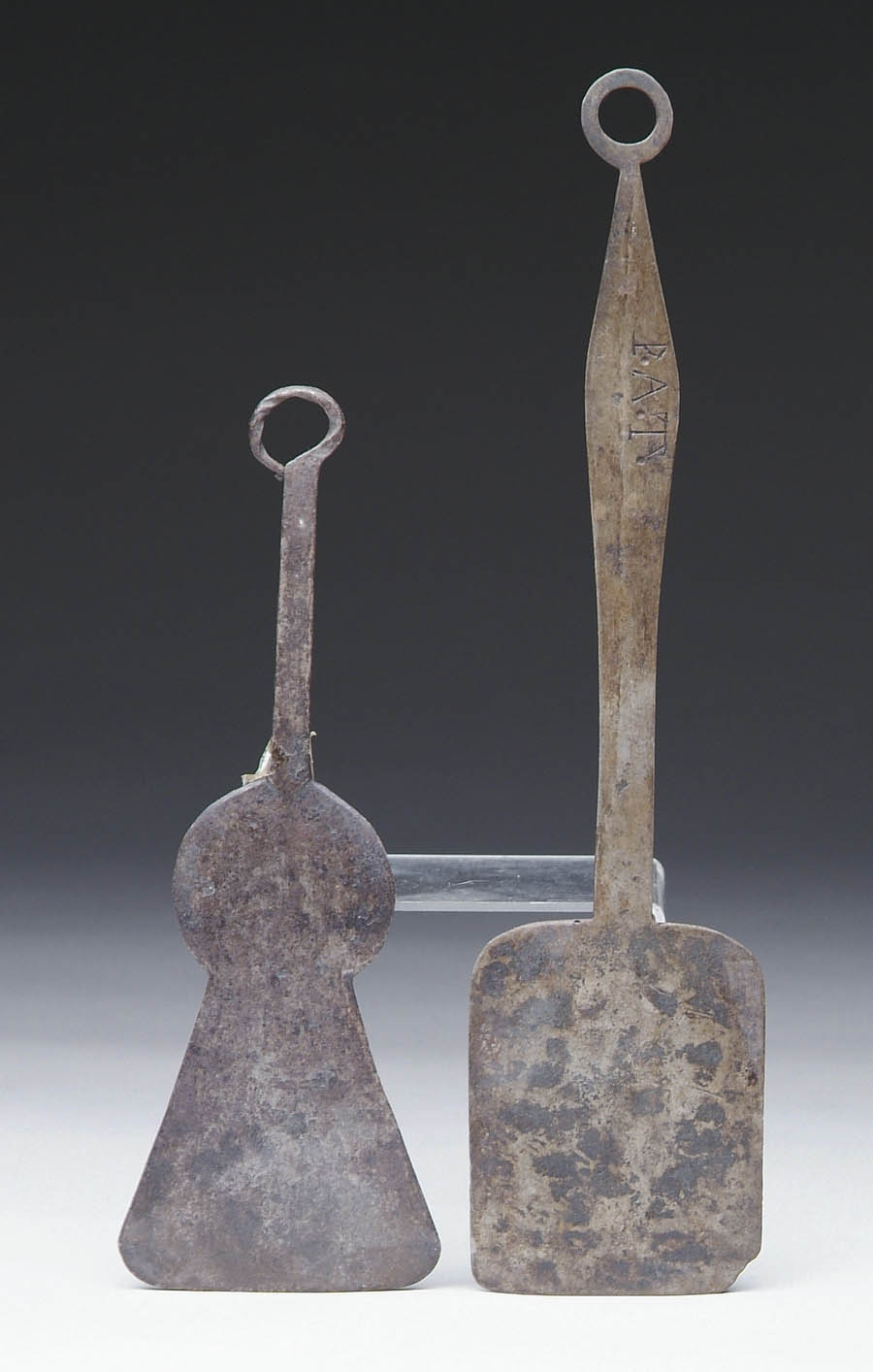 Appraisal: TWO IRON SPATULAS - shaped flat keyhole design with curled