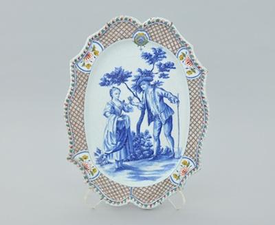 Appraisal: A Continental Faience Platter Of silver form with undulating rim