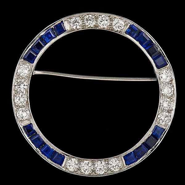 Appraisal: Sapphire Diamond Pin A platinum ''circle of life'' motif pin