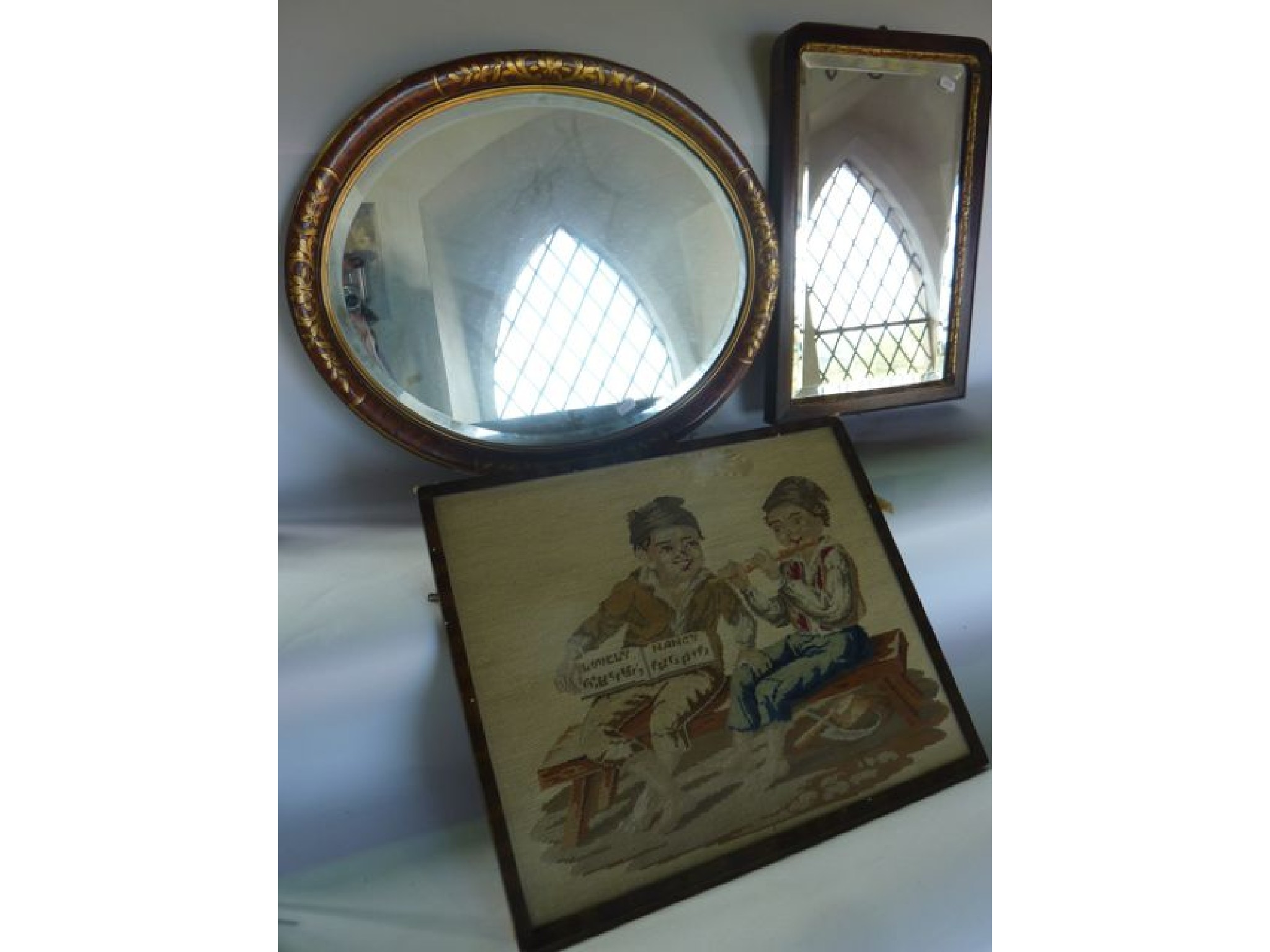 Appraisal: A framed and glazed embroidered scene of a child reading