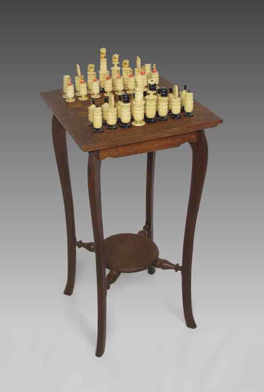 Appraisal: CARVED IVORY CHESS SET WITH TABLE Inlaid chess board top