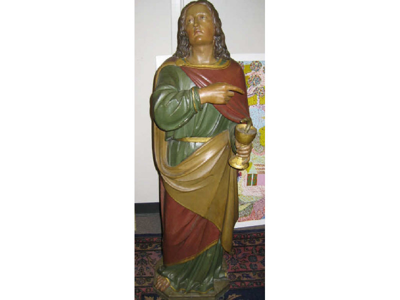 Appraisal: CARVED WOODEN RELIGIOUS FIGURE St John the Evangelist holding a