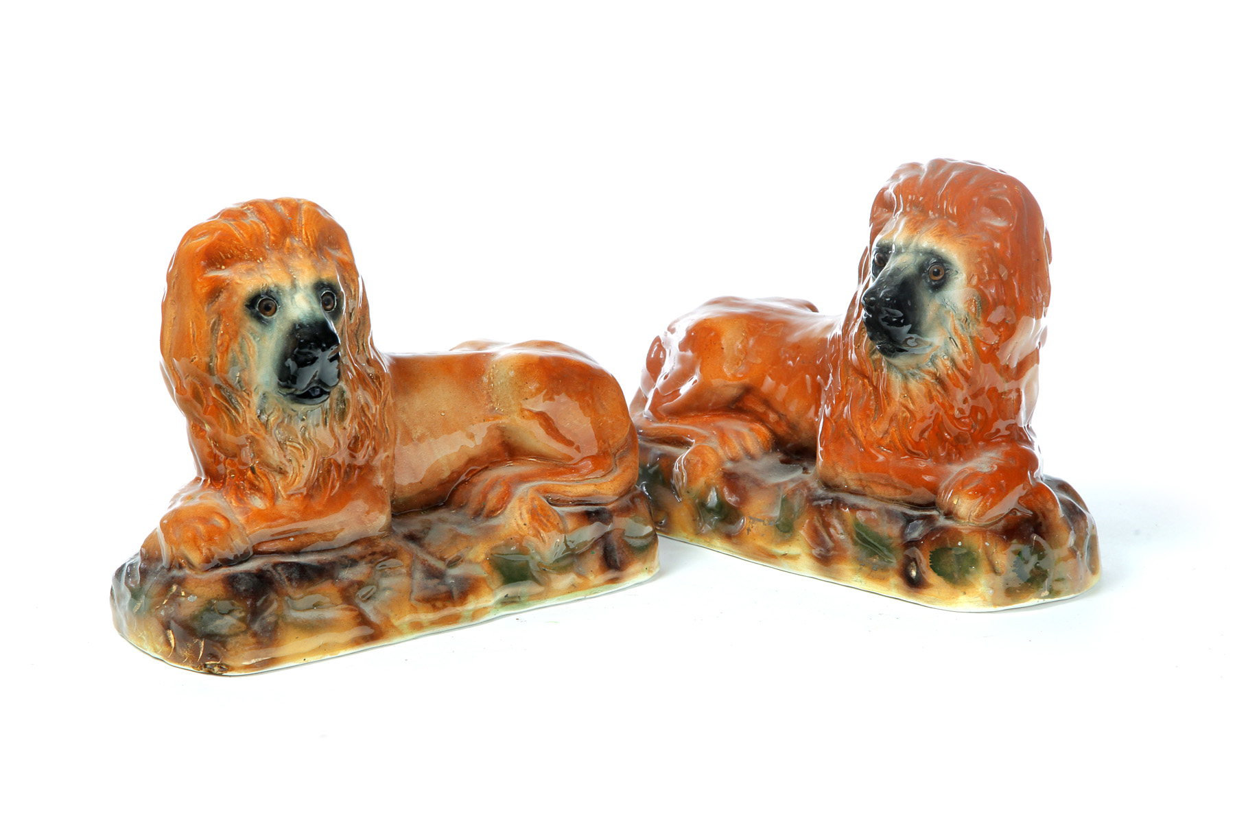 Appraisal: PAIR OF STAFFORDSHIRE LIONS England mid th century Reclining lions