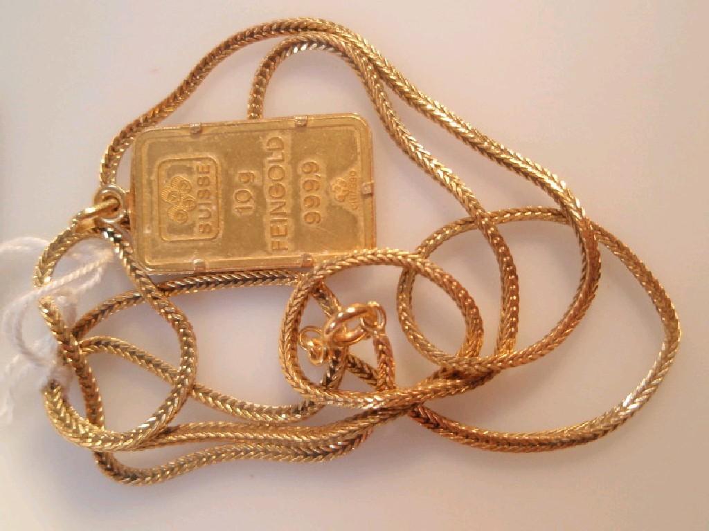 Appraisal: A gold 'ingot' pendant inscribed Suisse gm of feingold on