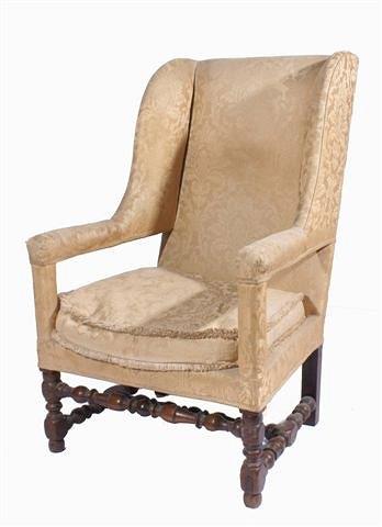 Appraisal: An antique mahogany wing back open armchair with upholstered back