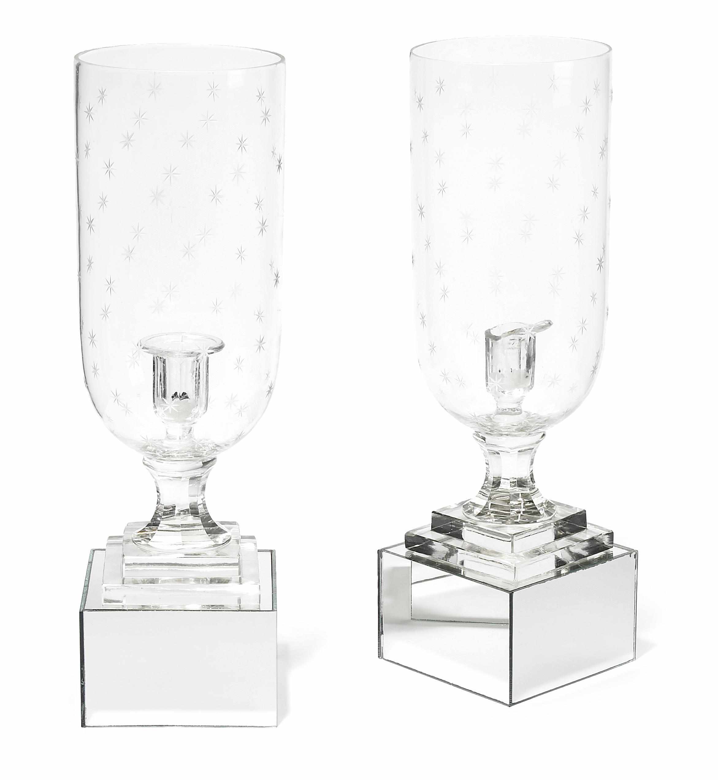 Appraisal: A pair of etched glass candlesticks with hurricane shades on