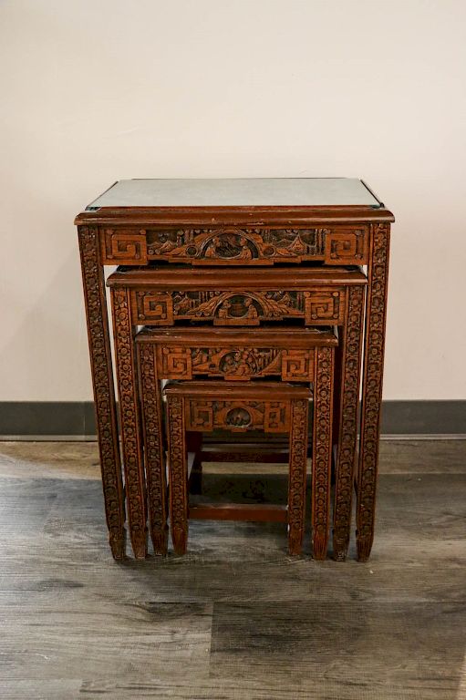 Appraisal: LACQUERED WOOD FOUR-PIECE NESTING TABLES SET TH C Carved delicately