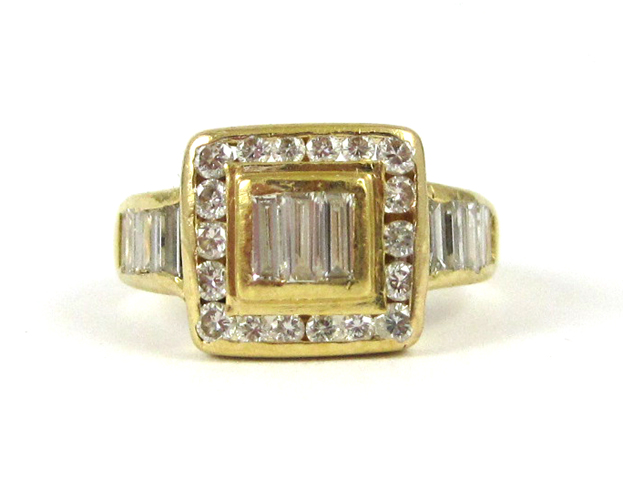 Appraisal: DIAMOND AND EIGHTEEN KARAT GOLD RING channel set with baguette-cut