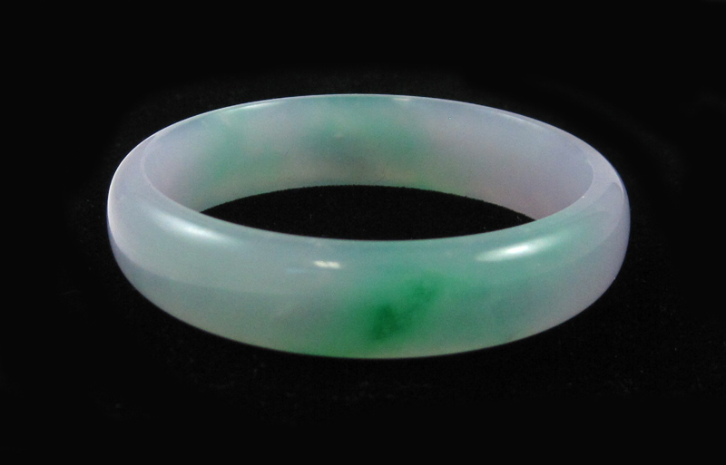 Appraisal: GREEN AND LAVENDER JADE BANGLE weighing grams and measuring approximately