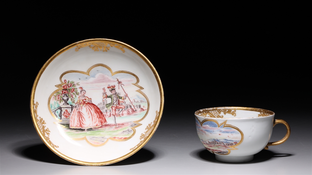 Appraisal: Meissen gilt and enameled porcelain cup and saucer with figural