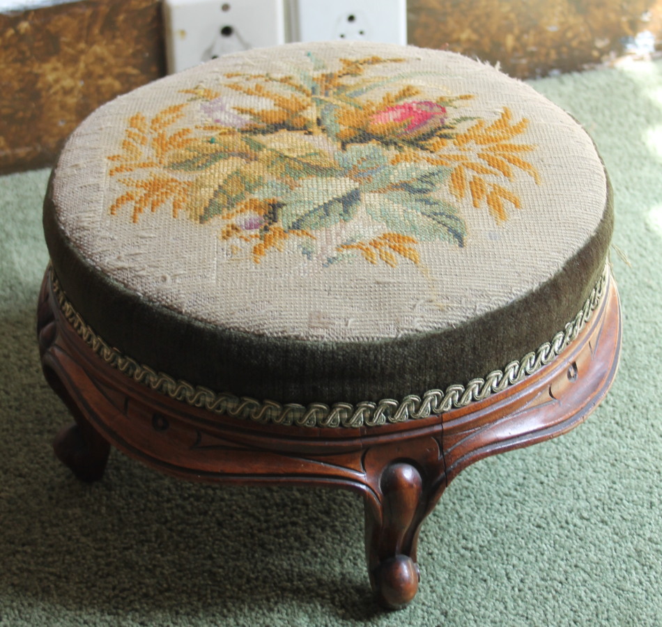 Appraisal: A Victorian footstool with a padded circular woolwork seat on