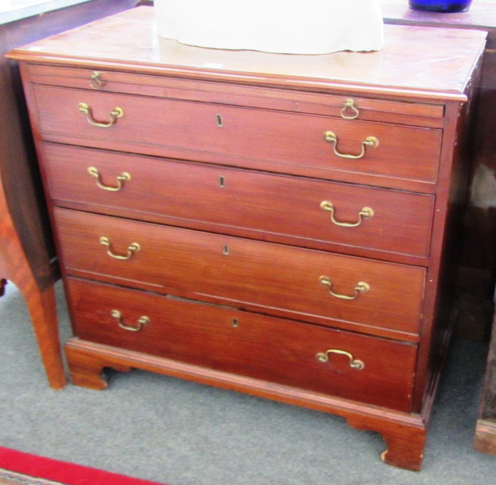 Appraisal: A George III mahogany chest the brushing slide over four