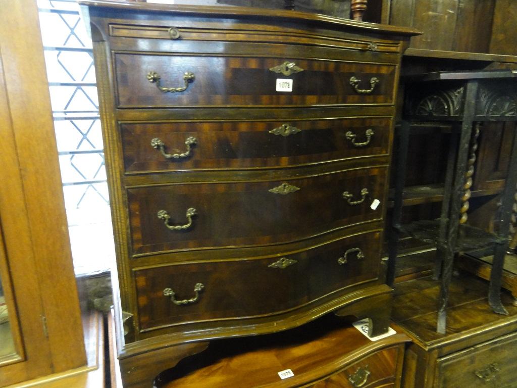 Appraisal: A reproduction mahogany serpentine chest in the Georgian style with