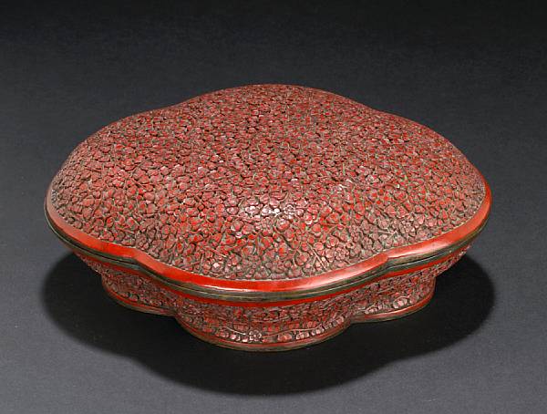 Appraisal: A cinnabar and black lacquer floriform box and cover Qianlong