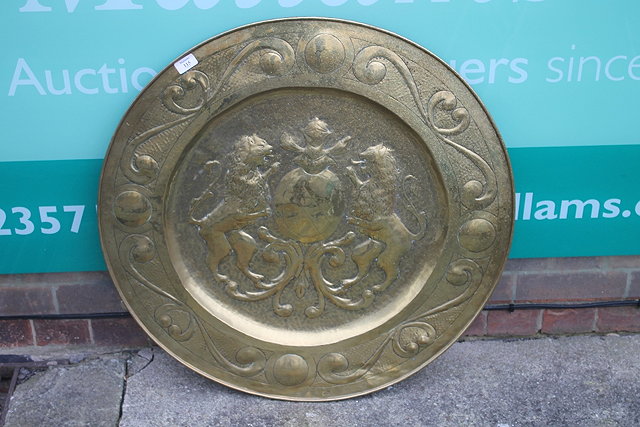 Appraisal: A CIRCULAR BRASS WALL PLAQUE embossed with armorial decoration cm