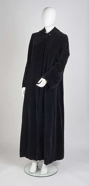 Appraisal: A long black velvet hooded coat red satin lining long