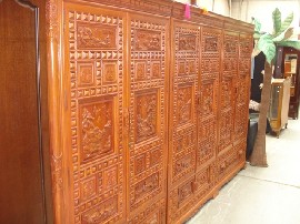 Appraisal: A Chinese ironwood six door cupboard with carved panels